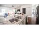 Close up on the granite countertop and sink, with a view to the open living area at 1112 Spann Ave, Indianapolis, IN 46203