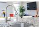 Modern kitchen sink with granite countertop and a view of the living area at 1112 Spann Ave, Indianapolis, IN 46203