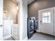 Well-lit laundry room with washer and dryer, with a gray color scheme and a sink inside a closet at 1112 Spann Ave, Indianapolis, IN 46203