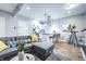 Open-concept living room with modern furniture, stainless steel accents, and a kitchen island with barstools at 1112 Spann Ave, Indianapolis, IN 46203