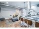 Living room view into kitchen, featuring island with bar seating, stainless hood, and gray sofa at 1112 Spann Ave, Indianapolis, IN 46203