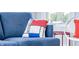 Living room detail showcasing a comfortable blue couch with a decorative Mondrian-style pillow at 1112 Spann Ave, Indianapolis, IN 46203