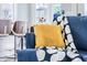 Living room detail showcasing a comfortable blue couch with decorative pillows and throw blanket at 1112 Spann Ave, Indianapolis, IN 46203