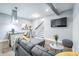 Open living space with a comfortable gray couch, leading to a modern kitchen, and adjacent staircase at 1112 Spann Ave, Indianapolis, IN 46203