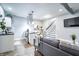 A contemporary living room flows into a bright kitchen, complemented by a cozy sofa and stylish decor at 1112 Spann Ave, Indianapolis, IN 46203