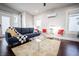 Comfortable living room featuring a modern sofa, glass coffee table, and bright decor at 1112 Spann Ave, Indianapolis, IN 46203