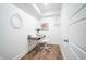 Small office space with hardwood floors, a minimalist desk, and a modern white chair at 1112 Spann Ave, Indianapolis, IN 46203