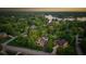 Aerial view showcasing a residence surrounded by lush trees, featuring a pool and nearby lake for scenic living at 11245 Old Stone Dr, Indianapolis, IN 46236
