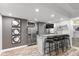 Modern bar area with counter seating, sleek appliances, and contemporary decor provides the perfect space for entertaining guests at 11245 Old Stone Dr, Indianapolis, IN 46236