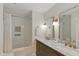 Bathroom featuring a double vanity with a marble countertop, framed mirrors, and a shower/tub combination with white subway tiles at 11245 Old Stone Dr, Indianapolis, IN 46236