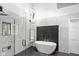 Bright and modern bathroom with an enclosed glass shower, marble accents, stand alone tub and contemporary light fixture at 11245 Old Stone Dr, Indianapolis, IN 46236