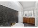 Spacious bathroom featuring double vanity, modern fixtures, stand alone tub, and a combination of sleek black and white marble at 11245 Old Stone Dr, Indianapolis, IN 46236