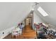 Bonus room offers hardwood floors, skylight, and space for a play area with toy kitchen and a drum set at 11245 Old Stone Dr, Indianapolis, IN 46236