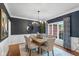 Charming dining room featuring a wooden table, elegant chandelier, and stylish decor for Gathering gatherings at 11245 Old Stone Dr, Indianapolis, IN 46236