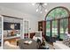 A luxurious home office with rich wood accents, modern lighting, and a view into a beautifully appointed dining room at 11245 Old Stone Dr, Indianapolis, IN 46236