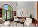 Stylish home office with large arched window, patterned floors, and sophisticated decor, ideal for productivity at 11245 Old Stone Dr, Indianapolis, IN 46236
