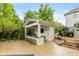 Entertainer's dream: outdoor bar area with seating, lighting, and an outdoor television overlooking the pool and lush landscaping at 11245 Old Stone Dr, Indianapolis, IN 46236