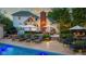 An alluring backyard oasis featuring a sparkling pool, luxurious lounge chairs, and a beautifully landscaped patio area at 11245 Old Stone Dr, Indianapolis, IN 46236