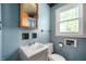 Bathroom showcasing a pedestal sink, toilet, and window with natural light at 11600 N 100 E, Morristown, IN 46161