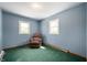 Bedroom showcasing a comfortable recliner, two windows, and neutral decor at 11600 N 100 E, Morristown, IN 46161