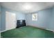 Simple bedroom featuring green carpets, light blue walls, and natural light through a window at 11600 N 100 E, Morristown, IN 46161