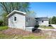 Home exterior features light gray siding, a back door, and a compact patio at 11600 N 100 E, Morristown, IN 46161