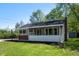 Quaint home featuring a screened front porch, brick accents, and a well-kept lawn, perfect for relaxing outdoors at 11600 N 100 E, Morristown, IN 46161