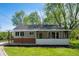 Charming single-story home with a screened porch, brick foundation, and a well-maintained front yard at 11600 N 100 E, Morristown, IN 46161