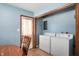 Functional laundry area equipped with a washer, dryer, and convenient access to the home's back entrance at 11600 N 100 E, Morristown, IN 46161