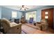 Inviting living room featuring comfortable seating, natural light, and a cozy fireplace, perfect for relaxation at 11600 N 100 E, Morristown, IN 46161