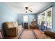 Comfortable living room with ample seating, natural light, a ceiling fan, and a decorative fireplace for a cozy ambiance at 11600 N 100 E, Morristown, IN 46161