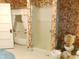 Retro bathroom features patterned wallpaper, shower, and vintage fixtures at 1207 Van Buskirk Rd, Anderson, IN 46011