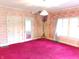 Cozy bedroom with pink carpet, classic wallpaper, and natural light at 1207 Van Buskirk Rd, Anderson, IN 46011