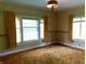 Spacious bedroom with plush carpet, vintage details, and bright natural light at 1207 Van Buskirk Rd, Anderson, IN 46011
