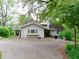Charming two-story home with a concrete driveway and mature trees at 1207 Van Buskirk Rd, Anderson, IN 46011