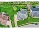Aerial view of a beautiful home showcasing its landscaped yard, patio, and surrounding neighborhood at 12152 Teal Ln, Carmel, IN 46032