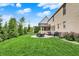 Expansive backyard with lush green lawn, patio, and mature trees, perfect for outdoor entertaining at 12152 Teal Ln, Carmel, IN 46032