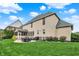 Large backyard featuring a patio, mature trees, and manicured lawn, great for outdoor activities at 12152 Teal Ln, Carmel, IN 46032