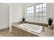 Bright bathroom showcasing the jetted tub with jets, natural light from the windows at 12152 Teal Ln, Carmel, IN 46032