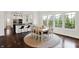 Bright dining area features large windows, a round area rug, and a view into the kitchen at 12152 Teal Ln, Carmel, IN 46032
