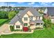 Stunning two-story home with a brick facade, manicured lawn, and charming front porch at 12152 Teal Ln, Carmel, IN 46032