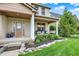 Inviting front porch with comfortable seating and swing, complemented by lush landscaping and a stylish entrance at 12152 Teal Ln, Carmel, IN 46032