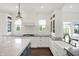 Bright, modern kitchen featuring custom white cabinetry, stainless steel appliances, and beautiful quartz countertops at 12152 Teal Ln, Carmel, IN 46032
