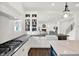 Modern kitchen with open layout, featuring white cabinets, dark countertops, and a view into the living space at 12152 Teal Ln, Carmel, IN 46032