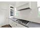 Stylish kitchen with subway tile backsplash, stainless steel stove, dark countertops, and ample cabinet space at 12152 Teal Ln, Carmel, IN 46032