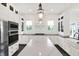 Bright kitchen featuring white cabinetry, a spacious island, modern stainless steel appliances, and pendant lighting at 12152 Teal Ln, Carmel, IN 46032