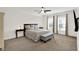 Spacious main bedroom with neutral tones, ceiling fan, and two windows at 12152 Teal Ln, Carmel, IN 46032