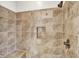 Close-up of a tiled walk-in shower featuring a built-in niche and decorative trim at 12152 Teal Ln, Carmel, IN 46032