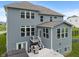 Rear view of home featuring a spacious deck, walkout basement, well-maintained lawn, and attractive blue siding at 12811 Corydon Dr, Fishers, IN 46037