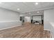 Finished basement with media center, neutral walls, wood-look flooring, and plenty of room for different activities at 12811 Corydon Dr, Fishers, IN 46037